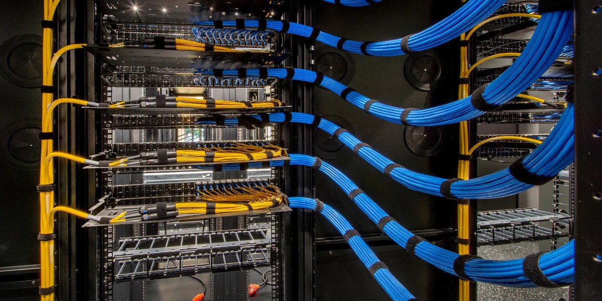 “Organized server wiring featuring blue and yellow Velcro ties for cable grouping and quick identification.